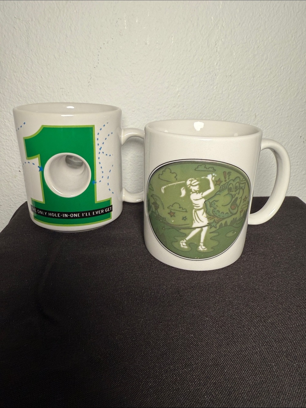 2 golf themed mugs. 1 Hallmark Shoebox & 1 Wonder Mug. Like new. 14oz & 12oz